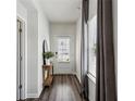 Inviting entryway with hardwood floors, white walls, and a view of the front door at 4389 Treadle Sw Rd, Mableton, GA 30126