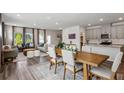 Open-concept living room and kitchen featuring hardwood floors and a dining table and modern decor at 4389 Treadle Sw Rd, Mableton, GA 30126