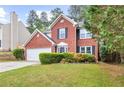 Lovely two-story red brick home with mature landscaping and an attached two-car garage at 2727 Northgate Nw Way, Acworth, GA 30101