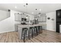 Modern eat-in kitchen features an island with stool seating, stainless appliances, and gray cabinetry at 7492 Knoll Hollow Rd, Lithonia, GA 30058