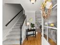 Elegant foyer featuring hardwood floors, staircase, and stylish decor at 2040 Parliament Dr, Lawrenceville, GA 30043