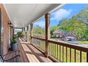 Inviting front porch with wooden decking, decorative columns, and serene neighborhood views at 2040 Parliament Dr, Lawrenceville, GA 30043