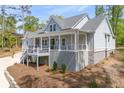 Beautiful two-story home featuring a welcoming front porch, gray siding, and a two car garage at 2841 Bettis Ct, Marietta, GA 30066