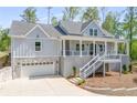Charming two-story home featuring a welcoming front porch, gray siding, and an attached two car garage at 2841 Bettis Ct, Marietta, GA 30066