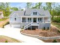Charming two-story home featuring a welcoming front porch, gray siding, and an attached two car garage at 2841 Bettis Ct, Marietta, GA 30066