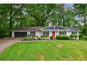 Charming single-story home with a lush green lawn and inviting curb appeal at 3803 Butternut Dr, Decatur, GA 30034
