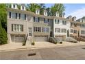 Charming townhomes with brick exteriors, dormer windows, and attached garages offer both style and convenience at 404 Wade Creek Rd, Alpharetta, GA 30009