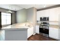 Open kitchen with granite countertops, stainless appliances, and hardwood floors at 10 Ne Perimeter Summit Ne Blvd # 4428, Brookhaven, GA 30319