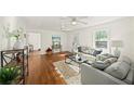 Bright living room with hardwood floors, a ceiling fan, and a comfortable seating area at 1961 Addison Ne Rd, Marietta, GA 30066
