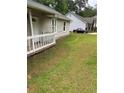 The home's front yard features green grass leading up to the porch with a burgundy vehicle in the distance at 2919 Cushing Ct, Jonesboro, GA 30238