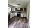 The spacious kitchen features white cabinets, stainless steel appliances, and stone countertops at 2919 Cushing Ct, Jonesboro, GA 30238
