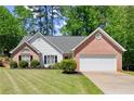 Attractive single-story home with brick and siding, complemented by a green lawn and fresh landscaping for curb appeal at 2880 Cressington Nw Bnd, Kennesaw, GA 30144