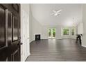 Spacious living room with vaulted ceiling, a fireplace, and new vinyl floors at 2880 Cressington Nw Bnd, Kennesaw, GA 30144