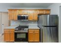 Contemporary kitchen featuring stainless steel appliances, light wood cabinets, and updated fixtures at 51 Legend Creek Way, Douglasville, GA 30134