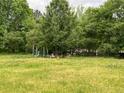 Large backyard with mature trees providing ample shade, toys are in the background at 6192 Meadowbrook Dr, Norcross, GA 30093