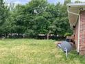 The backyard has mature trees and an AC unit; a satellite dish is visible near the brick wall at 6192 Meadowbrook Dr, Norcross, GA 30093
