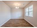 Bright entryway with wood-look floors, a chandelier, and neutral paint at 1003 Eldon Ln, Fairburn, GA 30213