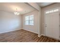 Inviting entryway with wood-look floors, a chandelier, and a white front door at 1003 Eldon Ln, Fairburn, GA 30213