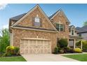A well-maintained brick home with a two-car garage and manicured landscaping at 280 Lakestone Pkwy, Woodstock, GA 30188