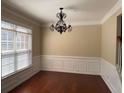Elegant dining room with dark hardwood floors, modern lighting and classic wainscoting detail at 308 Holbrook Rd # Bldg 11, Smyrna, GA 30082