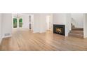 Spacious living room with fireplace, stairs and access to outdoor deck at 450 High Creek Trce, Roswell, GA 30076