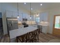 Well-appointed kitchen with stainless steel appliances, sleek white cabinetry, and granite countertops at 516 Barnwood Dr, Rockmart, GA 30153