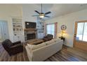 Comfortable living room featuring a stone fireplace, built-in shelving, and natural light at 516 Barnwood Dr, Rockmart, GA 30153
