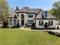 Beautiful home exterior with manicured lawn, elegant entryway, and classic architectural details at 1015 Bedford Gardens Dr, Alpharetta, GA 30022