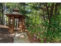 Charming backyard gazebo surrounded by flowering bushes, offering a secluded and peaceful retreat at 1015 Bedford Gardens Dr, Alpharetta, GA 30022