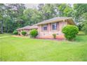 Well-manicured lawn and landscaping accentuates this delightful brick single-Gathering home at 2020 Buckingham Ct, Decatur, GA 30035
