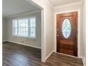 Inviting entryway with beautiful wood flooring and a decorative front door at 2814 Brackenwood Dr, Snellville, GA 30039