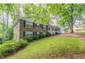 Well-maintained home with a lush lawn and mature trees providing shade at 2814 Brackenwood Dr, Snellville, GA 30039