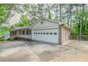 Spacious garage with a wide driveway and convenient side entrance to the home at 2814 Brackenwood Dr, Snellville, GA 30039