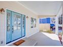 Covered front porch featuring a stylish blue door with glass panels, offering curb appeal at 3286 Bachelor St, East Point, GA 30344