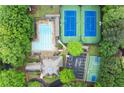 Aerial view of the pool, tennis courts, and basketball court surrounded by mature trees at 1431 Waterford Green Dr, Marietta, GA 30068