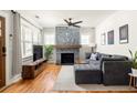 Cozy living room featuring a stone fireplace, hardwood floors, and a large window at 1598 Olympian Sw Cir, Atlanta, GA 30310