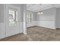 Dining room with gray walls, carpet, and a decorative chandelier at 209 Woodmill Sw Way, Atlanta, GA 30331