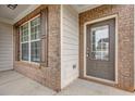Close up shot of the brick porch and glass-paneled front door at 209 Woodmill Sw Way, Atlanta, GA 30331