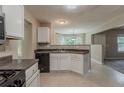 Functional kitchen with white cabinetry, dark countertops, and essential appliances for cooking at 4995 Panola Mill Dr, Lithonia, GA 30038