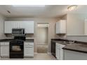 Well-equipped kitchen with sleek black appliances, complemented by ample storage and counter space at 4995 Panola Mill Dr, Lithonia, GA 30038