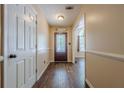 Bright foyer featuring hardwood floors and a decorative front door, creating a warm welcome at 5045 Edinborough Pl, Sugar Hill, GA 30518