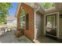 Inviting front entry with brick detail and a clear view of the door and surrounding landscape at 5045 Edinborough Pl, Sugar Hill, GA 30518