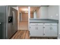 Open kitchen layout with stainless steel refrigerator and view to other rooms at 744 Brittany Ct, Stone Mountain, GA 30083