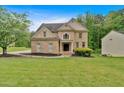 Beautiful brick home with an inviting front lawn, blending elegance and comfort in a neighborhood setting at 2480 Ashbourne Dr, Lawrenceville, GA 30043