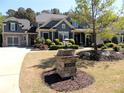 Beautiful two-story home with a brick facade, attached garage, mature landscaping and manicured lawn at 4960 Shade Creek Xing, Cumming, GA 30028
