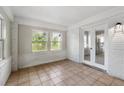 Bright sun room with white painted brick and tile flooring at 1825 Sw Willis Mill Rd, Atlanta, GA 30311