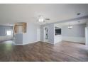 Spacious living area featuring hard floors and view of the staircase and kitchen at 4205 Royal Regency Nw Cir, Kennesaw, GA 30144
