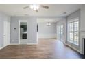 Bright living room with wood floors, view into dining and kitchen spaces at 4205 Royal Regency Nw Cir, Kennesaw, GA 30144