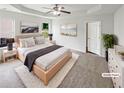 Serene main bedroom with a tray ceiling, soft carpet, and plenty of natural light from two windows at 4452 Belcamp Rd, Fairburn, GA 30213