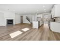 Open-concept living space with hardwood floors, fireplace, and access to kitchen at 361 Tallulah Ln, Grayson, GA 30017